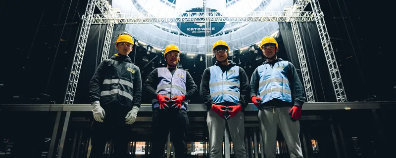 Four BWS crew members standing under the stage rig at Spodek arena